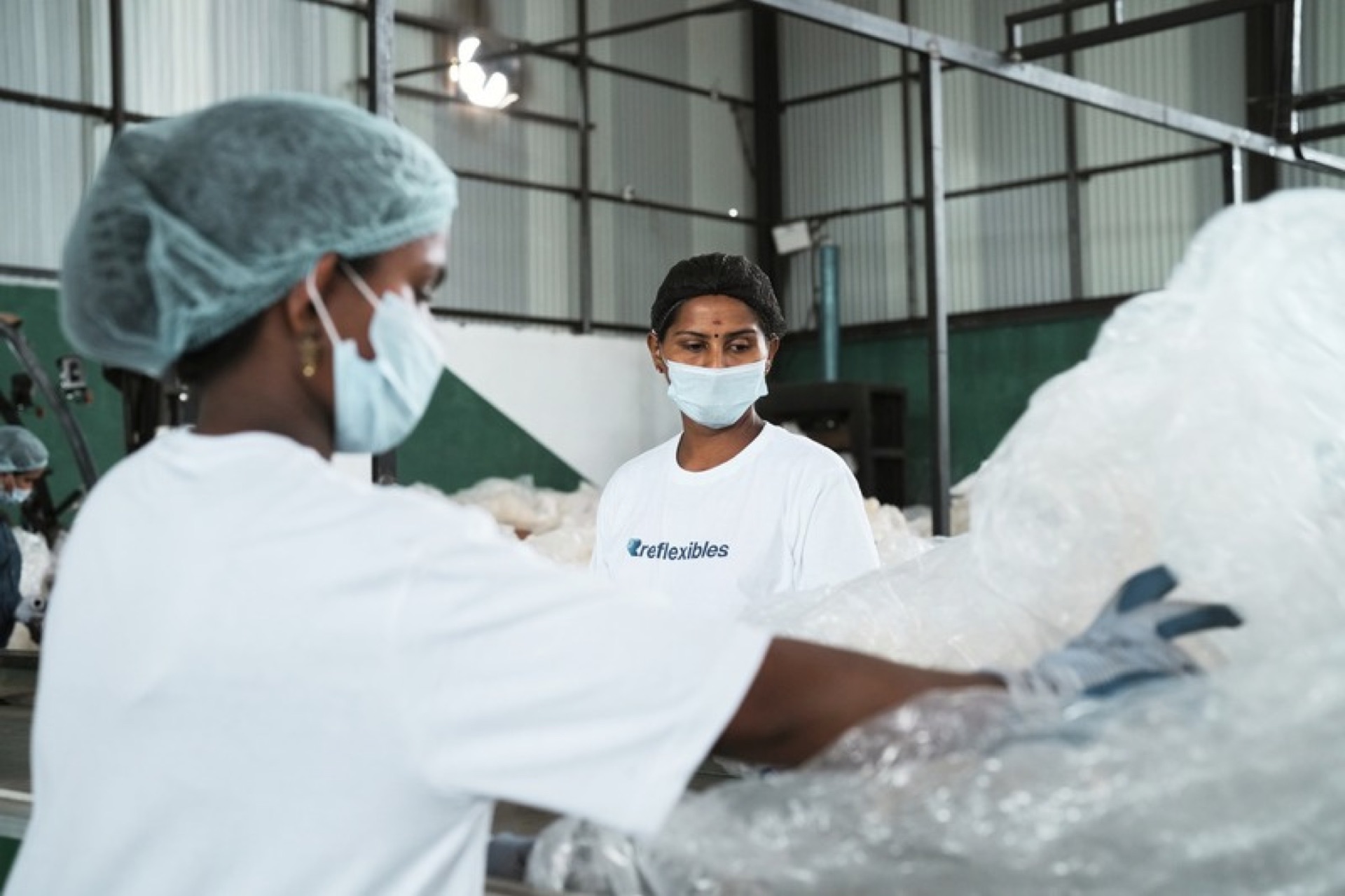 Workers sorting flexible plastic at the Reflexibles facility